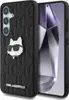 A black phone case with a Karl Lagerfeld monogram pattern and a Choupette cat head pin, placed next to a smartphone. Produktbild-Vorschau