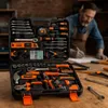 A man is working at a workbench with a tool kit open in the foreground. Produktbild-Vorschau