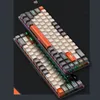 Two mechanical keyboards are shown in a diagonal view against a dark background with subtle graphic elements. Produktbild-Vorschau