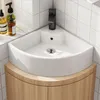A corner sink with a wooden cabinet underneath, set against a tiled wall. Anteprima dell’immagine prodotto