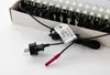 A close-up view of a black electrical plug and a red connector attached to a string of white LED lights, partially visible in a cardboard box. Produktbild-Vorschau