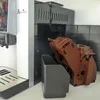 A coffee machine with its brewing unit removed, placed on a countertop. Produktbild-Vorschau