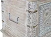 A close-up view of the side and corner of a wooden chest with decorative carvings and metal accents. Voir les images du produit