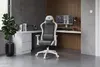 A gaming chair is set up in a modern home office with a desk, computer, and plant. Produktbild-Vorschau