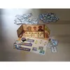A board game with cards and game pieces spread out on a wooden surface. Podgląd zdjęcia produktu