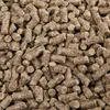 A close-up, overhead view of a pile of brown animal feed pellets. Podgląd zdjęcia produktu