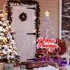 A snowy porch scene with a decorated Christmas tree and a lighted holiday decoration. Podgląd zdjęcia produktu