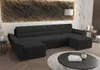 A dark gray U-shaped sectional sofa is shown in a modern living room setting, with a textured wall behind it and a coffee table in front. Náhled obrázku produktu