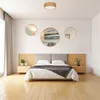 A bedroom scene with a bed, nightstands, and decorative mirrors on the wall. Produktbild-Vorschau