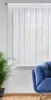 A white sheer curtain hangs in front of a window, with a blue armchair and a potted plant visible in the foreground. Náhled obrázku produktu