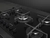 Close-up shot of a modern black gas stovetop with four burners and a control panel. Anteprima dell’immagine prodotto