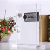 A digital peephole viewer is mounted on a clear acrylic stand, with a bouquet of flowers to the left and books to the right. Produktbild-Vorschau