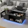 A modern black coffee table with a lift-top mechanism is shown in a living room setting, placed on a rug in front of a sofa. The table has integrated LED lighting. Produktbild-Vorschau