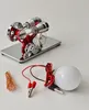 A scientific experiment model with a light bulb and wires on a white surface. Náhľad obrázku produktu