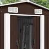 Close-up view of the top part of a brown metal shed with white trim, showing two vents and the open doorway with a ladder and shovel inside. Náhľad obrázku produktu