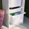 A close-up view of a white storage unit with open drawers, containing stationery and art supplies. Anteprima dell’immagine prodotto