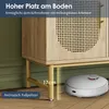 A robot vacuum cleaner is shown cleaning under a wooden cabinet with rattan accents, highlighting the space underneath. Podgląd zdjęcia produktu