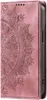 A close-up view of a rose gold phone case with a mandala design. Produktbild-Vorschau