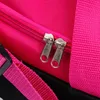 Close-up of zippers and strap on a pink and black bag. Podgląd zdjęcia produktu