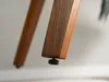 Close-up of the bottom of a wooden chair leg with an adjustable foot. Voir les images du produit