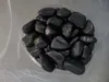 A pile of polished black stones in a plastic bag. Náhľad obrázku produktu