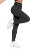 A person wearing dark gray leggings and white sneakers, shown from the waist down against a white background. Produktbild-Vorschau
