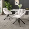 Two beige upholstered chairs with black metal legs are placed in a dining room setting. Voir les images du produit