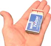 A hand holding a small box of matches. Produktbild-Vorschau