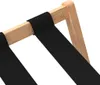 A close-up view of a luggage rack made of bamboo and black fabric straps. Voir les images du produit