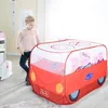 A young girl is playing with a Peppa Pig themed pop-up tent shaped like a car. Náhled obrázku produktu