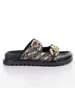 A single black sandal with a gold chain detail and a patterned strap, presented on a white background. Podgląd zdjęcia produktu