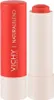 A close-up studio shot of a coral lipstick and its red casing. Podgląd zdjęcia produktu