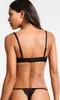 A woman wearing a black bra and thong, shown from the back. Produktbild-Vorschau