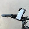 A close-up view of a black bicycle handlebar with a phone holder attached, holding a smartphone. Produktbild-Vorschau