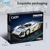 The image shows the packaging of a model car kit, with dimensions indicated. Produktbild-Vorschau