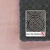 A close-up view of the underside of a pink rug, showing its anti-slip bottom with a magnified inset and text. Produktbild-Vorschau