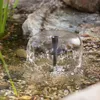 A close-up of a small water fountain in a pond or stream. Produktbild-Vorschau