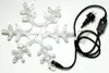 A clear product shot of a snowflake-shaped LED light with its power cord and plug. Produktbild-Vorschau