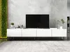 A modern white TV stand with a large black television on top, set against a textured gray wall. Produktbild-Vorschau