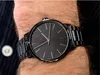 A close-up shot of a man's wrist wearing a black Armani Exchange watch. Anteprima dell’immagine prodotto