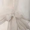 A close-up of a white sheer curtain with a tie knot. Produktbild-Vorschau