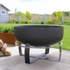 A fire pit on a wooden deck in a garden setting. Produktbild-Vorschau