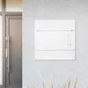 A white mailbox mounted on a textured gray wall next to a dark gray door. Produktbild-Vorschau