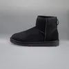 A black UGG boot is shown against a plain gray background. Náhľad obrázku produktu