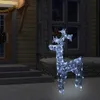 A lighted reindeer decoration stands on a paved area in front of a house with steps and windows. Produktbild-Vorschau