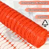 A roll of orange plastic safety netting is shown in the foreground, with a blurred background of a construction worker. Náhled obrázku produktu