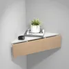 A corner shelf with a drawer, holding a plant and books. Voir les images du produit