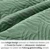 A close-up view of a green quilted fabric with a wave-like pattern. Produktbild-Vorschau