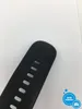 A close-up of a black smartwatch strap with holes for adjustment, against a white background. Voir les images du produit