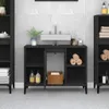 A black bathroom vanity with a white sink is shown in a well-lit room with tiled walls. Anteprima dell’immagine prodotto